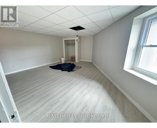 A room with a ceiling fan and a window.