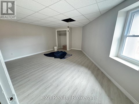 A room with a ceiling fan and a window.