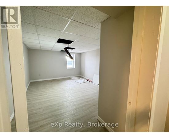 A room with a ceiling fan and a window.