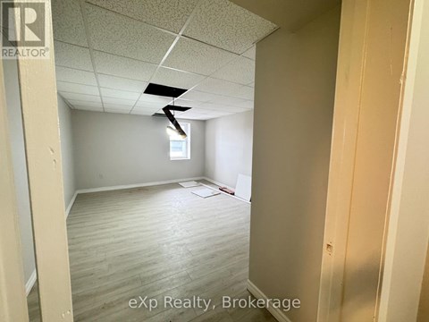 A room with a ceiling fan and a window.