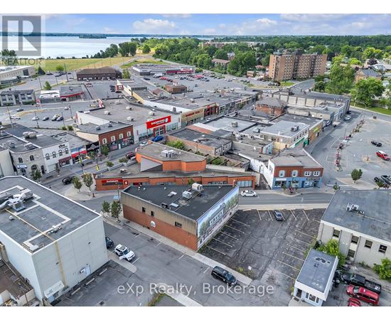 A large expanse of buildings with a parking lot in the foreground.