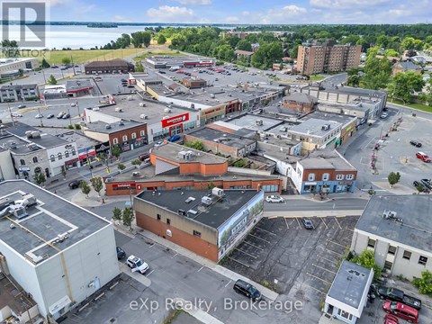 A large expanse of buildings with a parking lot in the foreground.