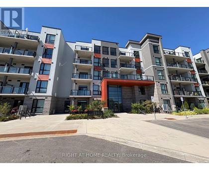 A multi-story residential building with balconies and a red entrance.