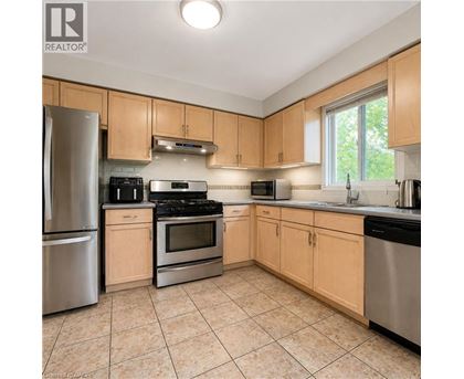 A kitchen with wooden cabinets and stainless steel appliances.