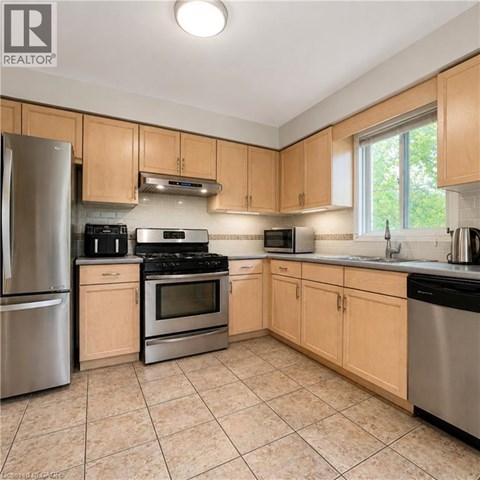 A kitchen with wooden cabinets and stainless steel appliances.