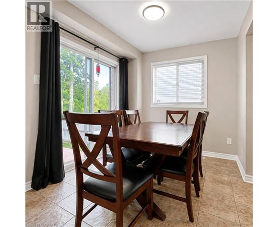 A dining room with a wooden table and chairs.