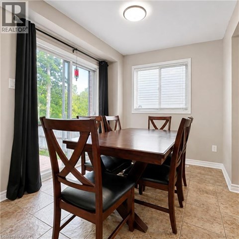 A dining room with a wooden table and chairs.