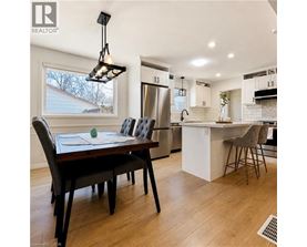 A modern kitchen with a dining table and chairs.