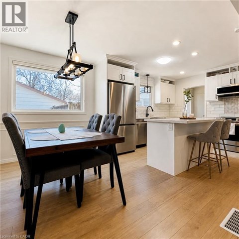 A modern kitchen with a dining table and chairs.