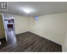 A room with wooden flooring and a white ceiling.
