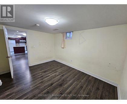 A room with wooden flooring and a white ceiling.
