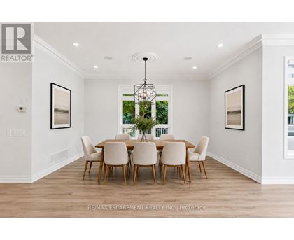 A dining room with a table set for six.