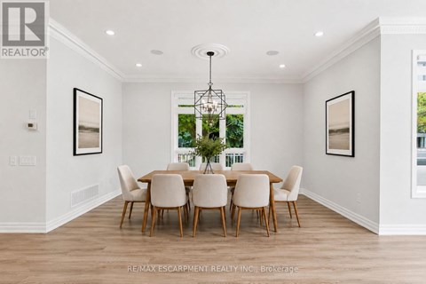 A dining room with a table set for six.