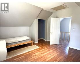 A bedroom with a bed and a door.