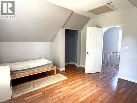 A bedroom with a bed and a door.