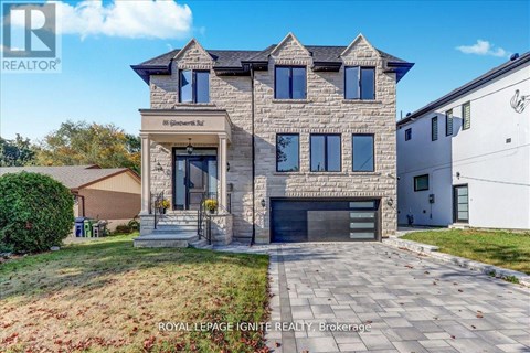 A large, modern house with a stone facade and a large front yard.