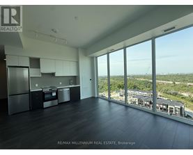A spacious kitchen with a view of the cityscape.
