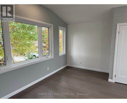A room with a large window and a door.