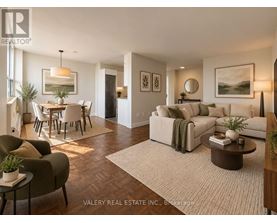 A living room with a couch, chairs, and a dining table.