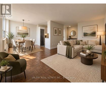 A living room with a couch, chairs, and a dining table.