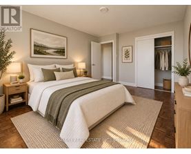 A bedroom with a large bed and a painting on the wall.
