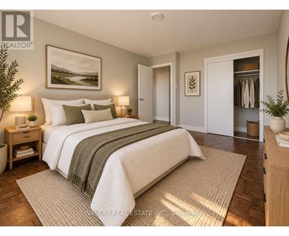A bedroom with a large bed and a painting on the wall.