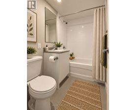 A bathroom with a toilet, sink, and shower.