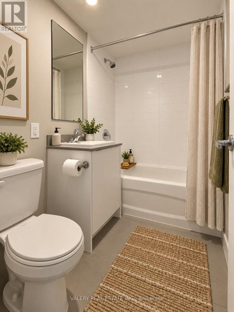 A bathroom with a toilet, sink, and shower.