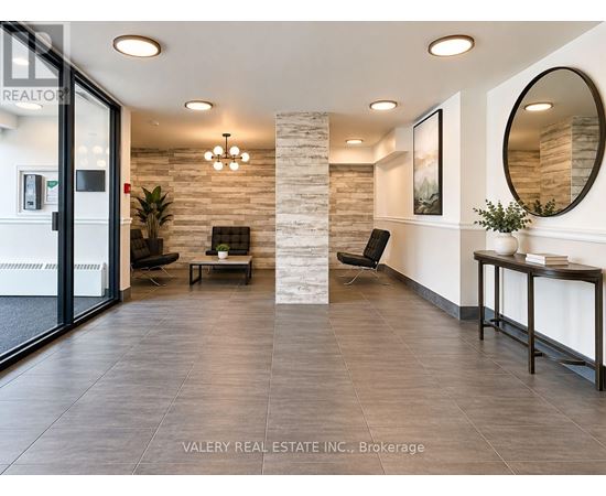 A real estate office with a glass door and a stone pillar.