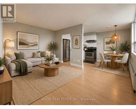 A living room with a couch, coffee table, and a dining table.