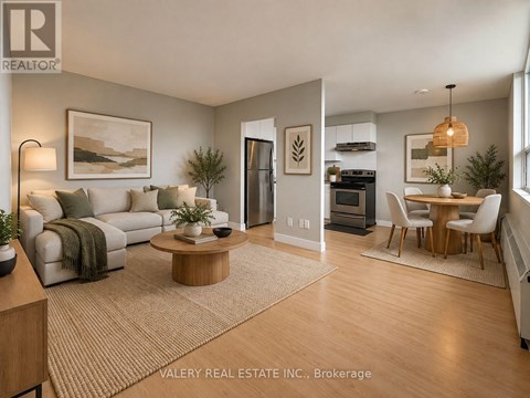 A living room with a couch, coffee table, and a dining table.