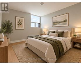 A bedroom with a large bed and a painting on the wall.