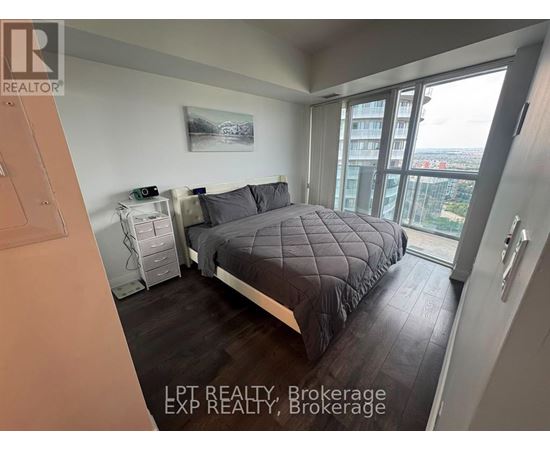 A bedroom with a large bed and a view of the city.
