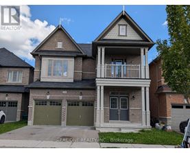 A two-story house with a garage is for sale.