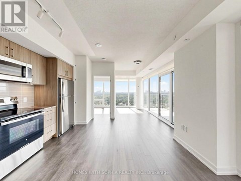 A spacious kitchen with wooden cabinets and a large island.