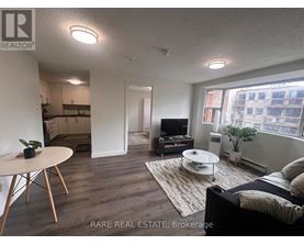 A living room with a couch, a table, and a television.