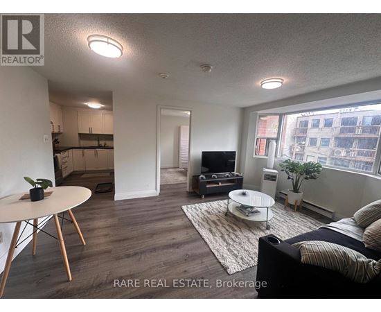 A living room with a couch, a table, and a television.
