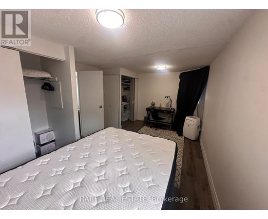 A bedroom with a large bed and a small closet.