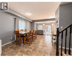 A dining room with a table set for six.