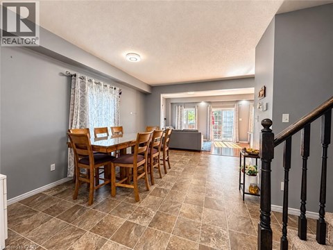 A dining room with a table set for six.