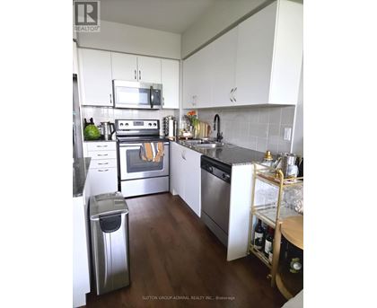 A kitchen with white cabinets and a stainless steel dishwasher.