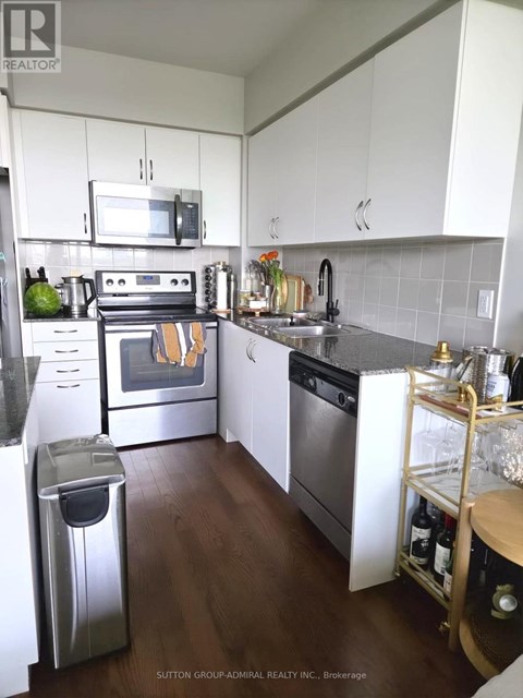 A kitchen with white cabinets and a stainless steel dishwasher.