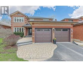 A house with a brick facade and a grey garage door.