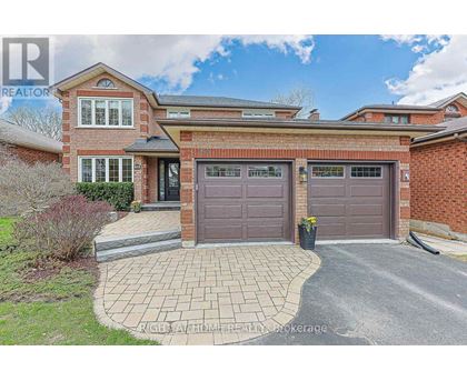 A house with a brick facade and a grey garage door.