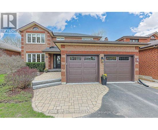A house with a brick facade and a grey garage door.