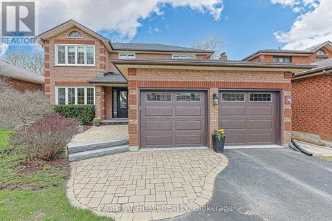 A house with a brick facade and a grey garage door.