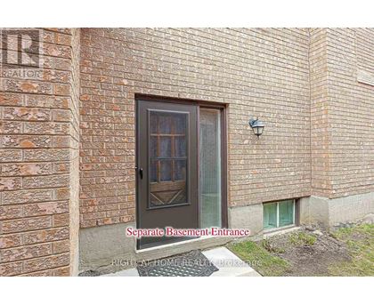 A brick building with a separate basement entrance.