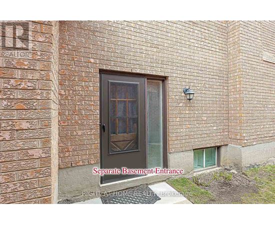 A brick building with a separate basement entrance.
