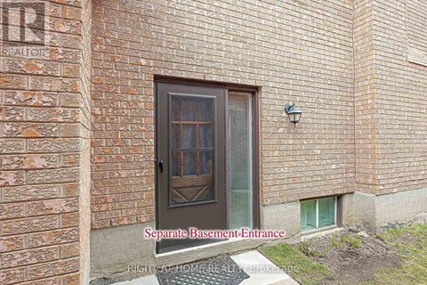 A brick building with a separate basement entrance.