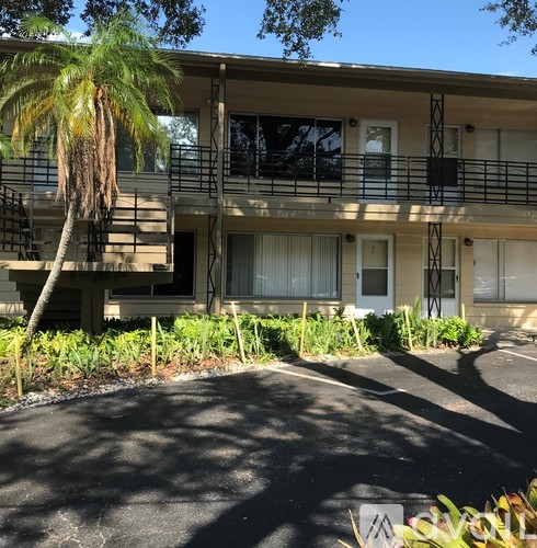 A building with a palm tree in front of it.